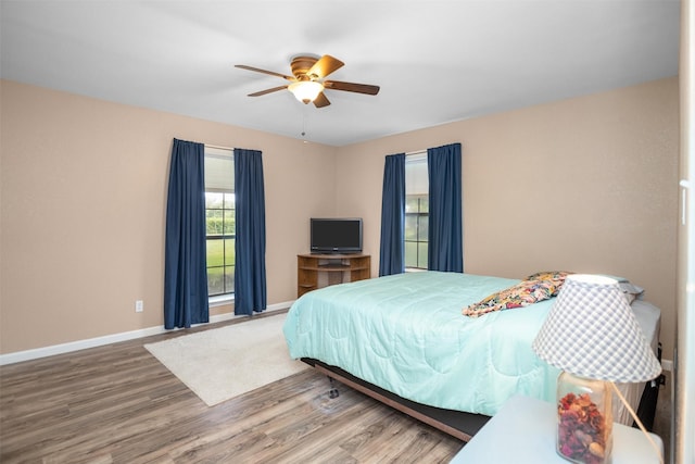 416 State Highway 21 E, Crockett, TX 75835 - bedroom featuring wood finished floors, baseboards, and a ceiling fan