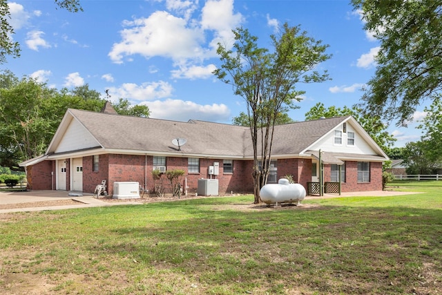 416 State Highway 21 E, Crockett, TX 75835 - view of front of home featuring an attached garage, brick siding, concrete driveway, and central AC