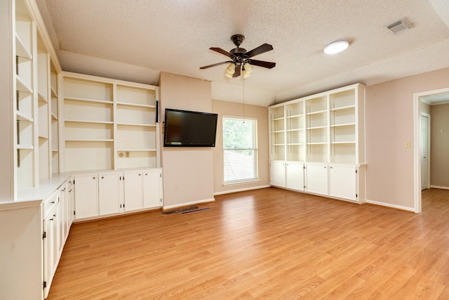 333 Banyan Dr, Lake Jackson, TX 77566 - unfurnished living room featuring a textured ceiling, a ceiling fan, light wood finished floors, and baseboards