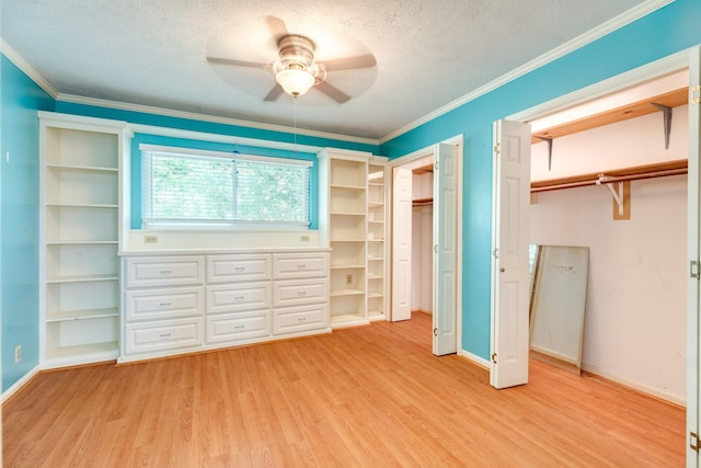 333 Banyan Dr, Lake Jackson, TX 77566 - unfurnished bedroom with two closets, light wood-style flooring, a textured ceiling, ornamental molding, and baseboards