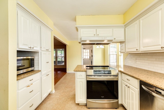 333 Banyan Dr, Lake Jackson, TX 77566 - kitchen with appliances with stainless steel finishes, decorative backsplash, white cabinetry, and light stone counters