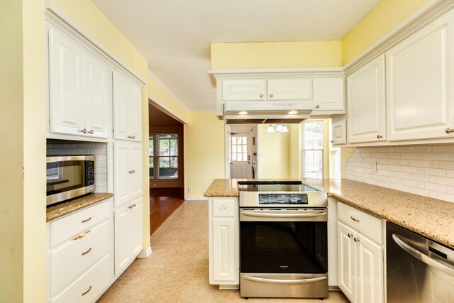 333 Banyan Dr, Lake Jackson, TX 77566 - kitchen with stainless steel appliances, tasteful backsplash, white cabinets, and light stone counters
