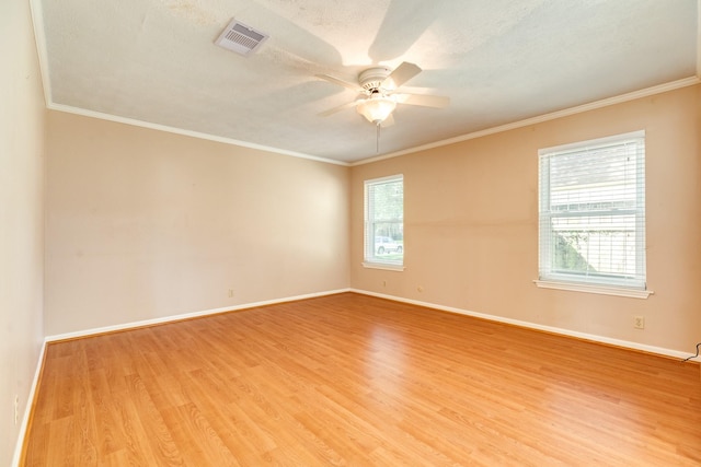 333 Banyan Dr, Lake Jackson, TX 77566 - spare room featuring plenty of natural light, ceiling fan, light wood-style flooring, baseboards, and crown molding