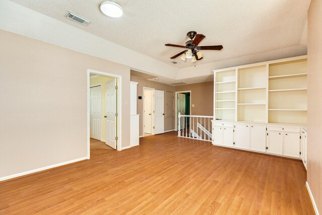 333 Banyan Dr, Lake Jackson, TX 77566 - spare room featuring light wood finished floors, ceiling fan, baseboards, and a textured ceiling