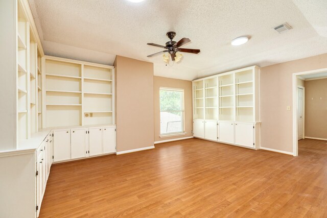 333 Banyan Dr, Lake Jackson, TX 77566 - unfurnished living room with a textured ceiling, ceiling fan, light wood-style flooring, and baseboards