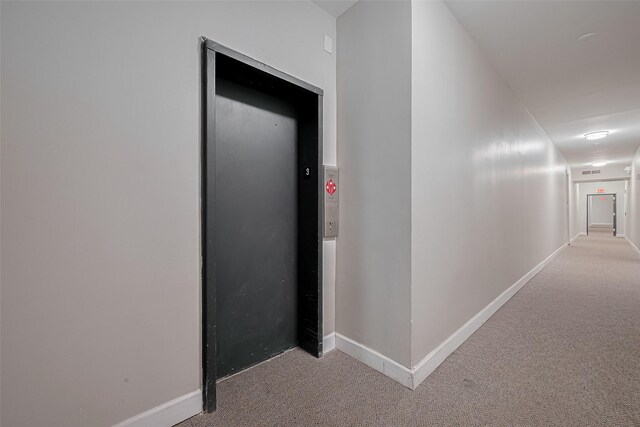 4515 Briar Hollow Pl Unit 307, Houston, TX 77027 - hallway with carpet flooring, baseboards, and elevator