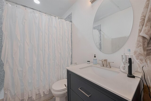 4515 Briar Hollow Pl Unit 307, Houston, TX 77027 - bathroom featuring vanity, toilet, and curtained shower