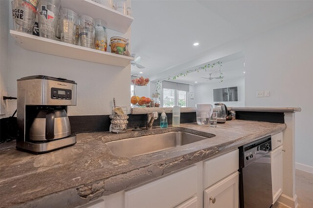 4515 Briar Hollow Pl Unit 307, Houston, TX 77027 - kitchen featuring dishwasher, a sink, white cabinets, recessed lighting, and baseboards