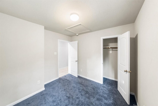 15229 Travis Ln, Willis, TX 77378 - unfurnished bedroom featuring carpet floors, attic access, baseboards, and a closet