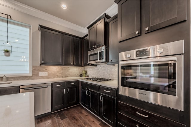 8670 Green Kolbe Ln, Houston, TX 77080 - kitchen with appliances with stainless steel finishes, ornamental molding, light countertops, dark wood-style flooring, and backsplash