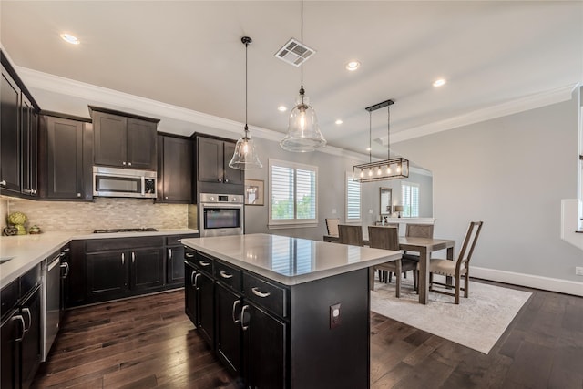 8670 Green Kolbe Ln, Houston, TX 77080 - kitchen with stainless steel appliances, crown molding, backsplash, light countertops, and dark wood finished floors