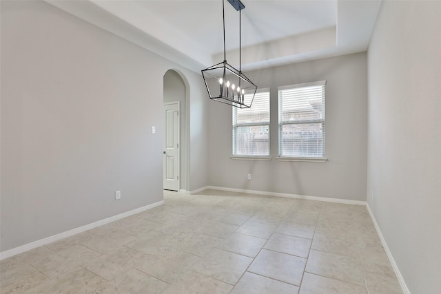 10014 Mahaffey Rd, Tomball, TX 77375 - unfurnished dining area featuring arched walkways, a chandelier, light tile patterned floors, and baseboards