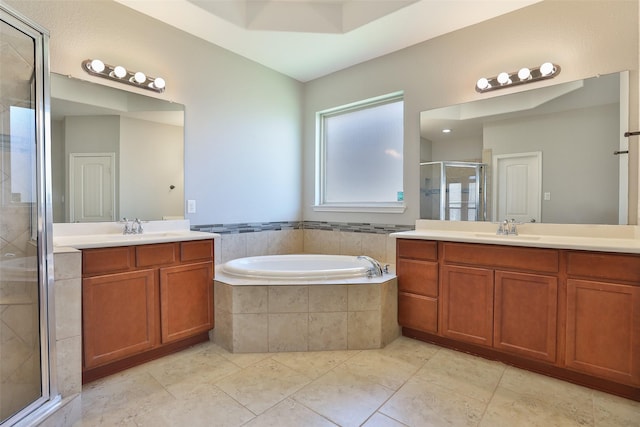 10014 Mahaffey Rd, Tomball, TX 77375 - bathroom featuring a stall shower, a bath, two vanities, and tile patterned flooring