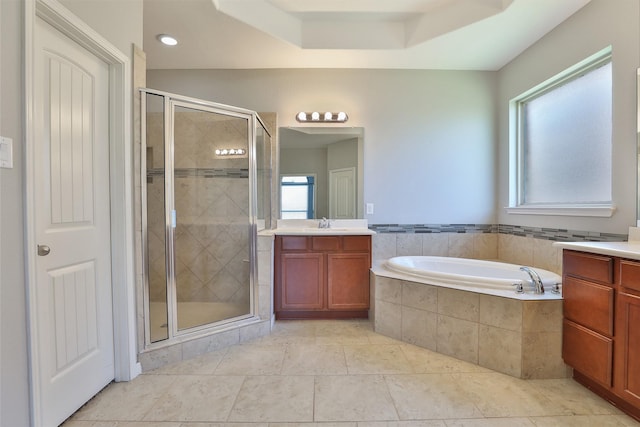 10014 Mahaffey Rd, Tomball, TX 77375 - bathroom featuring a stall shower, a garden tub, vanity, tile patterned flooring, and a tray ceiling