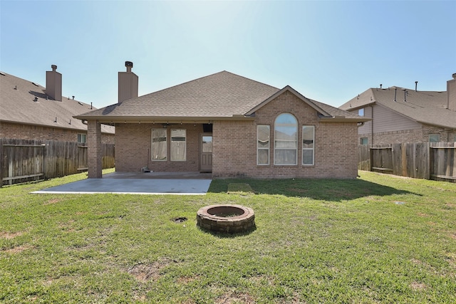 10014 Mahaffey Rd, Tomball, TX 77375 - back of property featuring a patio, an outdoor fire pit, brick siding, and a chimney