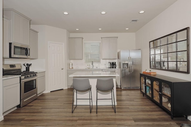 10137 Whooping Crane Way, Magnolia, TX 77354 - kitchen featuring stainless steel appliances, a sink, backsplash, a kitchen island, and light countertops