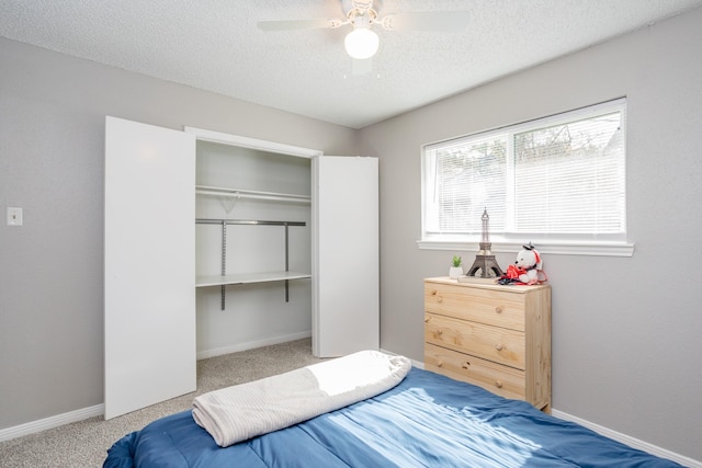 16014 Sweet Fern St, Houston, TX 77070 - bedroom featuring a closet, carpet flooring, baseboards, a textured ceiling, and ceiling fan