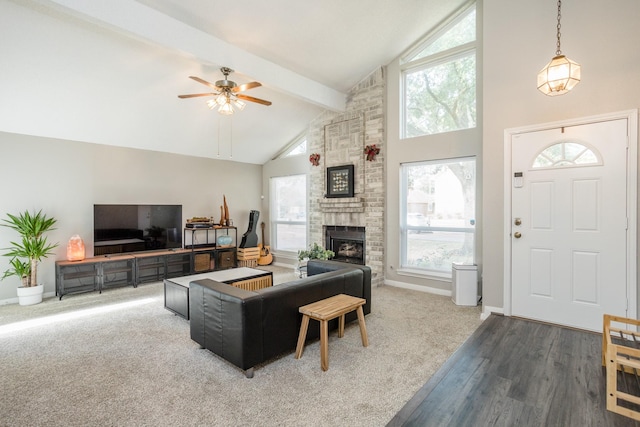 16014 Sweet Fern St, Houston, TX 77070 - living room featuring beamed ceiling, a ceiling fan, high vaulted ceiling, a fireplace, and wood finished floors