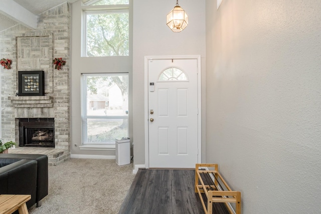 16014 Sweet Fern St, Houston, TX 77070 - entrance foyer with a brick fireplace, beam ceiling, high vaulted ceiling, baseboards, and carpet