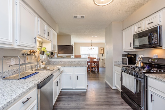 16014 Sweet Fern St, Houston, TX 77070 - kitchen featuring black appliances, a peninsula, dark wood-style floors, white cabinetry, and a textured ceiling