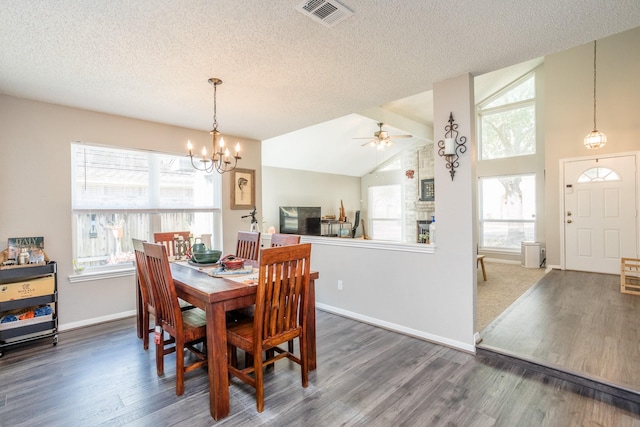 16014 Sweet Fern St, Houston, TX 77070 - dining room featuring wood finished floors, a chandelier, a textured ceiling, baseboards, and ceiling fan