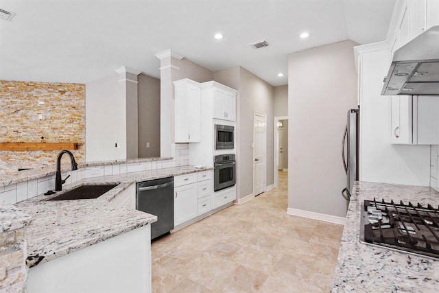 16502 Lasting Light Ln, Houston, TX 77095 - kitchen with appliances with stainless steel finishes, a sink, under cabinet range hood, light stone countertops, and white cabinetry