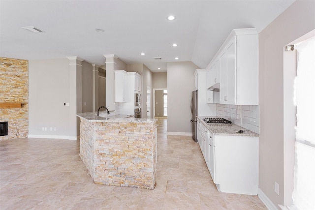 16502 Lasting Light Ln, Houston, TX 77095 - kitchen with stainless steel appliances, light stone countertops, white cabinetry, decorative backsplash, and recessed lighting
