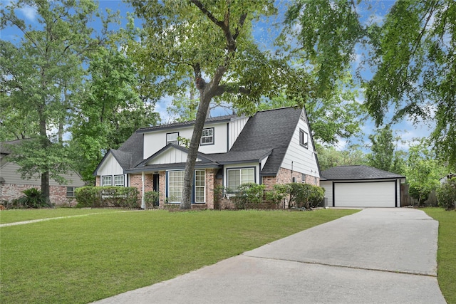 5815 Old Lodge Dr, Houston, TX 77066 - view of front facade featuring brick siding, an outbuilding, board and batten siding, and a front yard