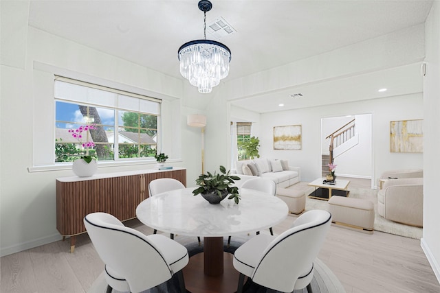 5815 Old Lodge Dr, Houston, TX 77066 - dining room featuring light wood-style flooring, a chandelier, baseboards, and stairway