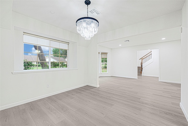5815 Old Lodge Dr, Houston, TX 77066 - unfurnished room featuring a chandelier, light wood-style flooring, baseboards, and stairs
