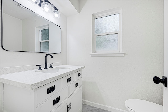 5815 Old Lodge Dr, Houston, TX 77066 - bathroom featuring toilet, vanity, baseboards, and marble finish flooring