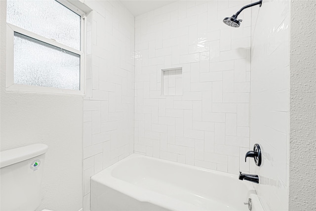 5815 Old Lodge Dr, Houston, TX 77066 - full bathroom featuring toilet, washtub / shower combination, and a textured wall