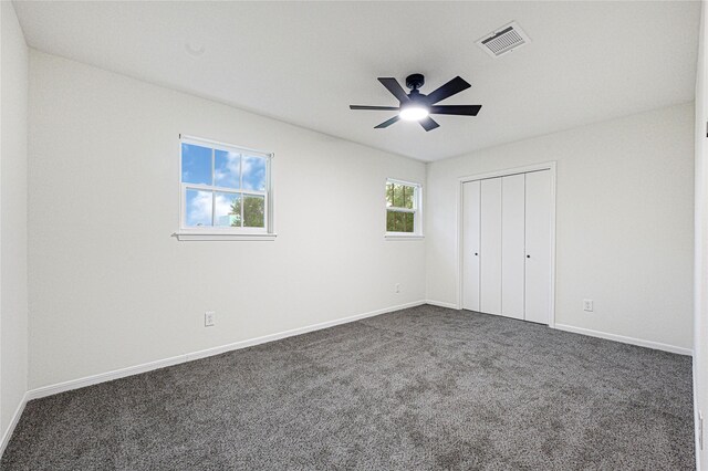5815 Old Lodge Dr, Houston, TX 77066 - unfurnished bedroom featuring dark carpet, baseboards, a closet, and a ceiling fan