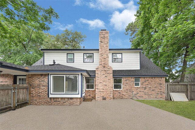 5815 Old Lodge Dr, Houston, TX 77066 - rear view of house with a patio, brick siding, and a chimney