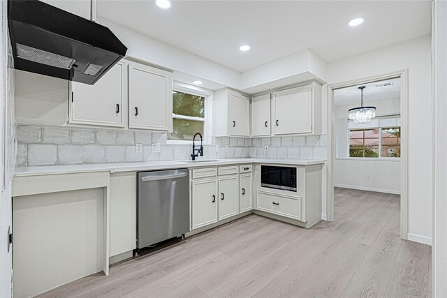 5815 Old Lodge Dr, Houston, TX 77066 - kitchen featuring stainless steel dishwasher, a sink, under cabinet range hood, black microwave, and light wood-style floors
