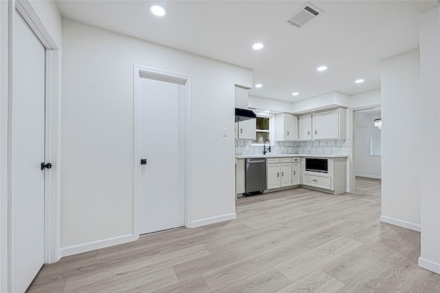 5815 Old Lodge Dr, Houston, TX 77066 - kitchen featuring stainless steel dishwasher, light countertops, light wood-style flooring, recessed lighting, and built in microwave