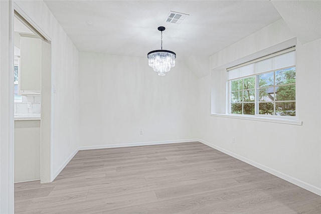 5815 Old Lodge Dr, Houston, TX 77066 - empty room featuring a chandelier, light wood-style flooring, and baseboards