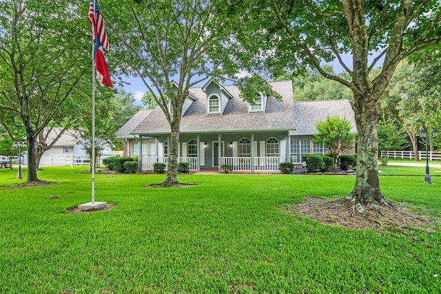 20103 Faye St, Tomball, TX 77377 - new england style home with a porch, a front lawn, and a shingled roof