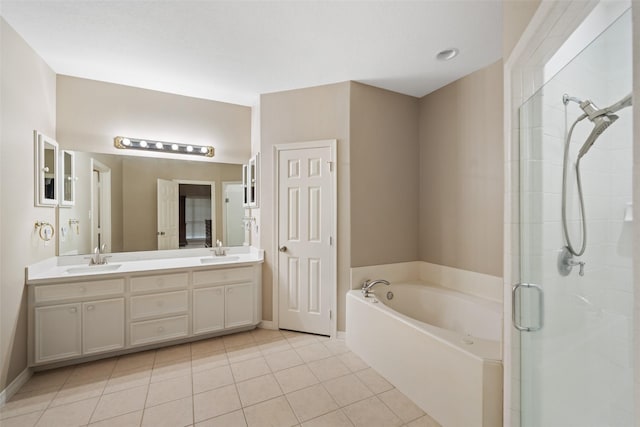 20103 Faye St, Tomball, TX 77377 - bathroom with a shower stall, tile patterned floors, a bath, double vanity, and baseboards
