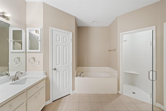 20103 Faye St, Tomball, TX 77377 - bathroom featuring a bath, tile patterned floors, a stall shower, vanity, and baseboards