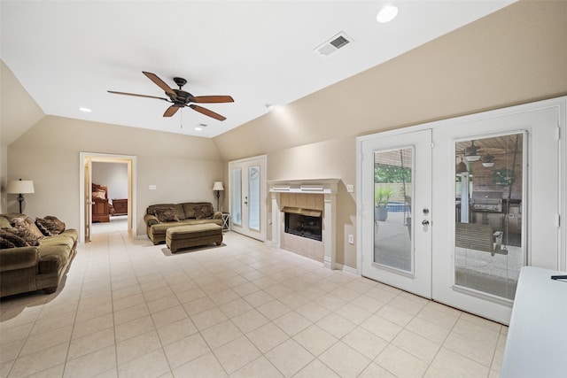 20103 Faye St, Tomball, TX 77377 - living area with ceiling fan, french doors, vaulted ceiling, a tiled fireplace, and light tile patterned floors