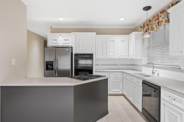 20103 Faye St, Tomball, TX 77377 - kitchen with black appliances, a sink, white cabinets, light countertops, and decorative light fixtures