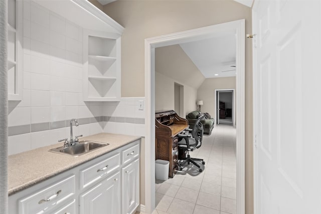 20103 Faye St, Tomball, TX 77377 - kitchen with a sink, decorative backsplash, light countertops, light tile patterned flooring, and white cabinets