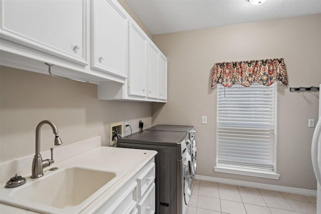 20103 Faye St, Tomball, TX 77377 - clothes washing area with separate washer and dryer, cabinet space, baseboards, and light tile patterned flooring