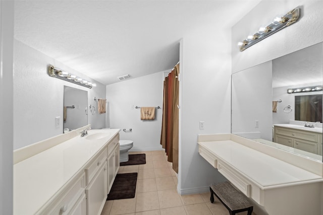 20103 Faye St, Tomball, TX 77377 - full bath featuring toilet, tile patterned flooring, two vanities, and baseboards