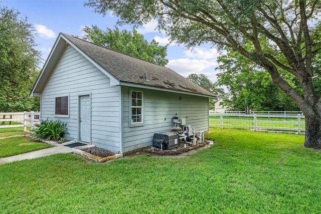 20103 Faye St, Tomball, TX 77377 - view of side of home with a shingled roof and an outbuilding