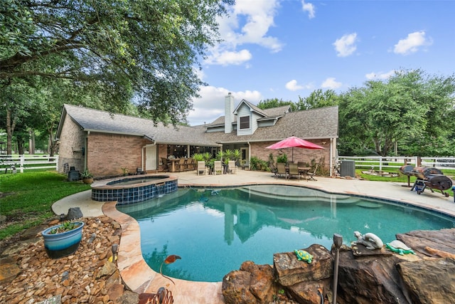 20103 Faye St, Tomball, TX 77377 - view of swimming pool featuring fence, a patio area, outdoor dining area, and a pool with connected hot tub