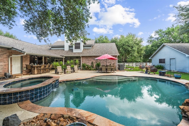20103 Faye St, Tomball, TX 77377 - view of swimming pool featuring outdoor dining area, fence, a patio area, and a pool with connected hot tub