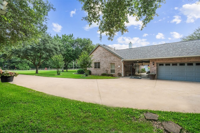 20103 Faye St, Tomball, TX 77377 - view of front of house with brick siding, a front yard, a chimney, a garage, and driveway