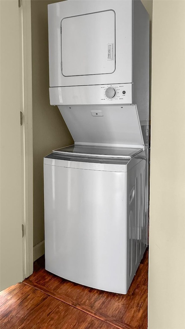 2121 El Paseo St Unit 1511, Houston, TX 77054 - washroom featuring stacked washer / dryer and dark wood-style flooring